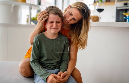 Photo for Portrait of mother consoling her crying sad injured son. Child family support pain parent concept - Royalty Free Image