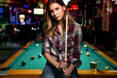 Photo for Young beautiful girl is playing billiards. Pleasant pastime, rest, fun entertainment concept - Royalty Free Image