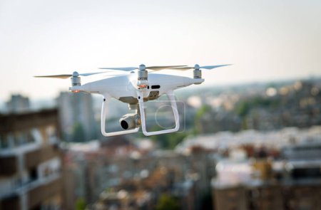 Foto de Drone with camera close up on the grey background. Preparation quadrocopter to start flying outdoor. - Imagen libre de derechos