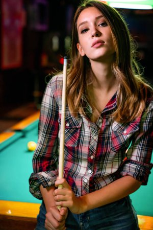 Photo for Portrait of beautiful young sexy woman in billiard club - Royalty Free Image