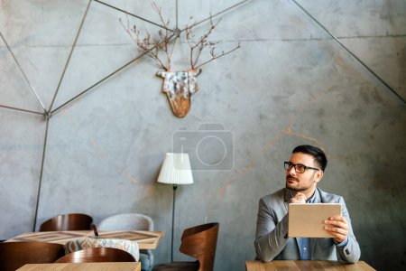 Photo for Portrait of young business man working online on digital tablet. Business people technology concept - Royalty Free Image
