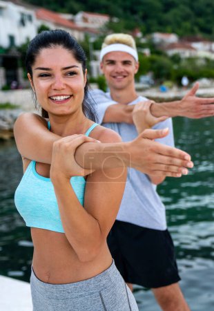 Photo for Group of cheerful fit fitness friends team exercising together outdoor. Sport people fitness health concept - Royalty Free Image