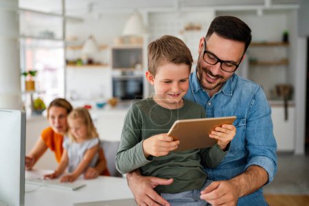 Photo for Digital device technology family online education concept. Happy young family with digital devices at home. - Royalty Free Image