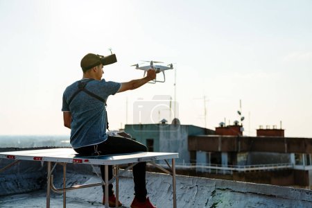 Téléchargez les photos : Jeune technicien volant drone UAV avec télécommande extérieure - en image libre de droit