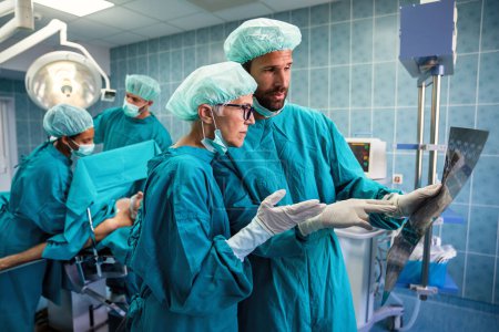 Photo for Surgery, medicine and people concept. Group of surgeons at operation in operating room at hospital - Royalty Free Image