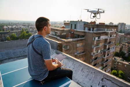 Téléchargez les photos : Homme avec drone volant à l'extérieur de la ville. - en image libre de droit