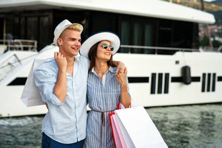 Photo for Portrait of happy couple with shopping bags. People sale consumerism vacation travel lifestyle concept. - Royalty Free Image