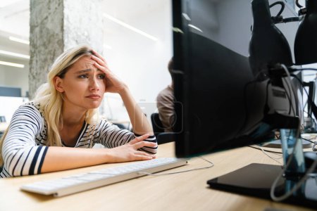 Photo for Portrait of a disappointed woman programmer looking stressed out while working on a computer code at night. - Royalty Free Image