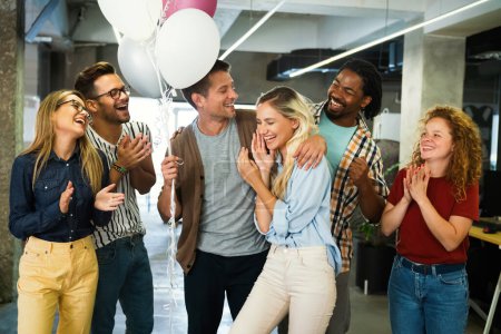 Photo for Happy multiracial young group of business people having fun while celebrating on surprise party in the office. - Royalty Free Image