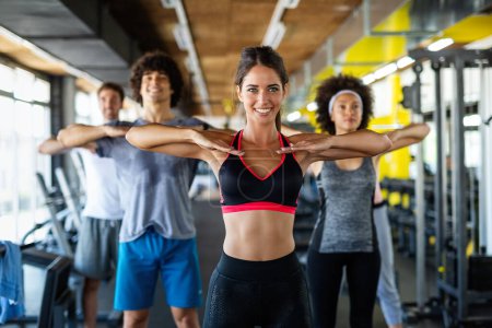 Photo for Fitness, sport, people and lifestyle concept. Group of smiling people exercising together in gym or studio - Royalty Free Image