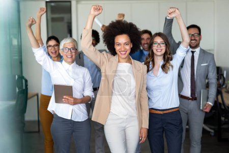 Photo for Group of successful happy multiethnic business people celebrating a good job in the office - Royalty Free Image