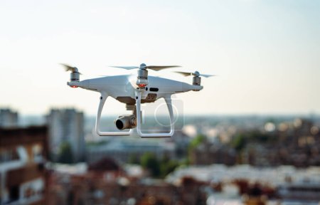 Close up white drone quadcopter with digital camera outdoors