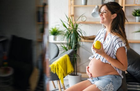 Foto de Nutrición y dieta durante el embarazo. Mujer joven embarazada presta atención a los alimentos saludables y vitaminas - Imagen libre de derechos