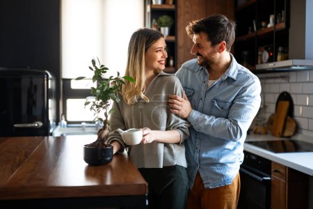 Photo for Loving everything about her. Beautiful young couple bonding and smiling. Smiling environmentally friendly couple with houseplant - Royalty Free Image