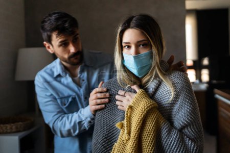 Photo for Loving man husband taking care of his sick wife, checking fever. Young woman suffering with cold and flu, cancer - Royalty Free Image
