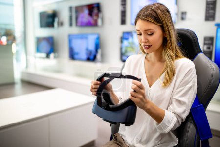Photo for Portrait of young woman using virtual reality headset at exhibition, show. VR technology simulation concept - Royalty Free Image