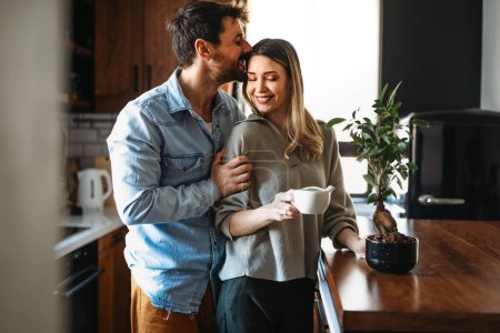Photo for Loving everything about her. Beautiful young couple bonding and smiling. Smiling environmentally friendly couple with houseplant - Royalty Free Image