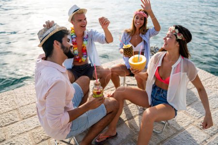 Photo for Group of happy friends having fun with tropical cocktails on beach party. Travel and summer vacation concept. - Royalty Free Image