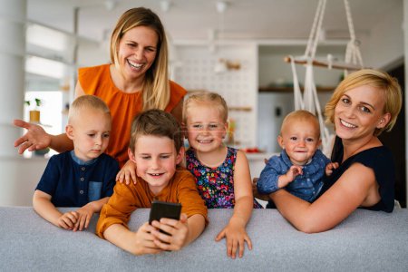 Photo for Portrait of happy big family. Gay couple of women smiling and having fun with her children at home - Royalty Free Image