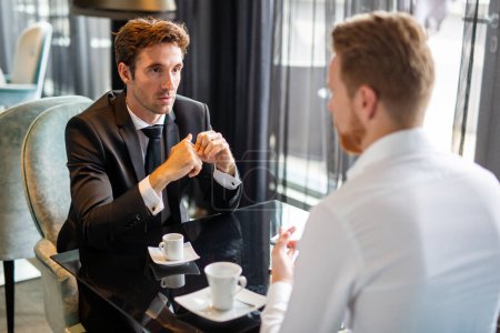 Photo for Business executive men, colleagues discussing work at meeting during coffee break. Business lunch, business people concept - Royalty Free Image