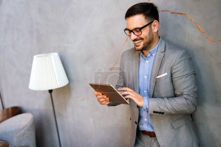 Photo for Portrait of young business man working online on digital tablet. Business people technology concept - Royalty Free Image