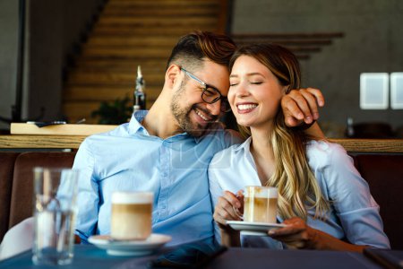 Photo for Romantic loving young couple drinking coffee, having a date in the cafe. - Royalty Free Image