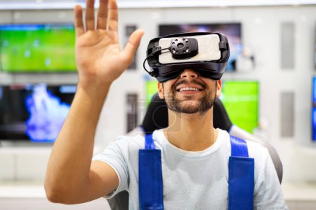 Photo for Portrait of young man using virtual reality headset at exhibition, show. VR technology simulation concept - Royalty Free Image