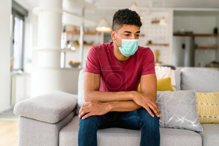 Photo for Portrait of african american man wearing surgical mask at home. Covid-19, coronavirus and quarantine concept. - Royalty Free Image