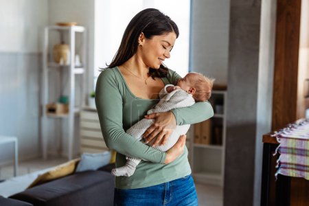 Foto de Mujer bonita sosteniendo a un bebé recién nacido en sus brazos. Concepto de madre soltera. Familia amor felicidad. - Imagen libre de derechos