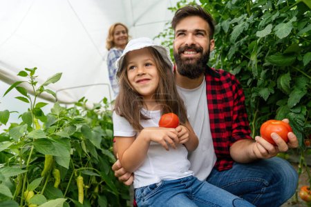 Foto de Familia con jardinería infantil feliz en la granja, el cultivo de verduras orgánicas. La gente cosecha concepto de comida saludable. - Imagen libre de derechos