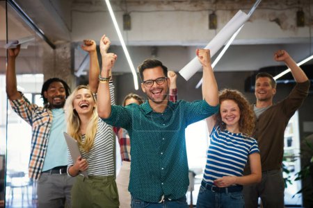 Photo for Happy diverse employees team celebrating success, business achievement hugging with smiling business team leader - Royalty Free Image
