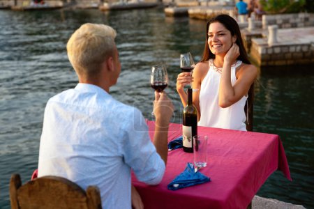 Photo for Honeymoon couple is having a private, romantic dinner at a tropical beach on summer vacation. - Royalty Free Image