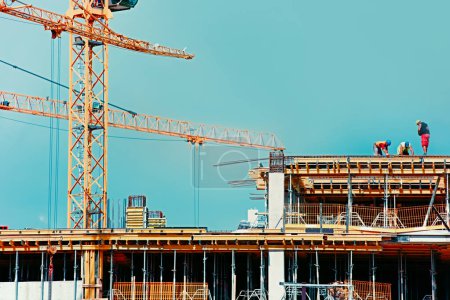 Photo for Large modern construction site including several cranes working on a building complex - Royalty Free Image