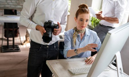 Photo for Close up of creative startup young business people with digital camera working together at designer agency in office - Royalty Free Image