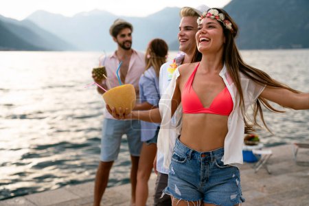 Photo for Chilling, dancing international youth, enjoying on resort beach pool sunny disco, in diverse trendy fashionable bikinies with cocktails. - Royalty Free Image