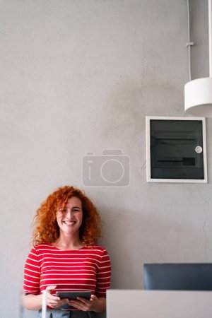 Photo for Urban happy business woman using tablet computer and working. Happy businesswoman using a digital tablet. Young leading businesswoman using a wireless tablet. - Royalty Free Image