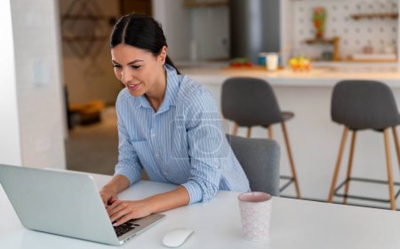 Successful positive caucasian business woman, executive, recruitment, product manager, work from home, looks at computer screen, satisfied with the result