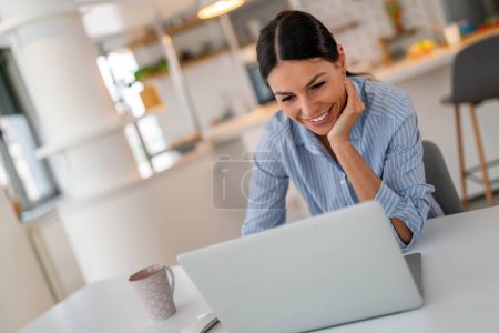 Photo for Beautiful young concentrated business woman wearing shirt using laptop in modern workspace. Freelancer, startup, social media people concept - Royalty Free Image