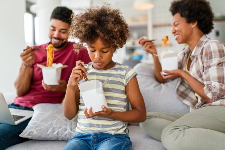 Photo for Family home delivary takeaway food concept. Happy african american family eating at living room and enjoying time together. - Royalty Free Image