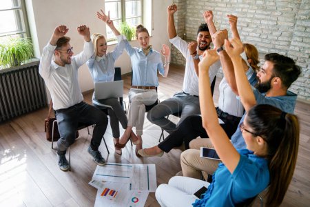 Photo for Happy diverse business team celebrating success and having fun all together. Group of cheerful ecstatic people in circle in office high five each other - Royalty Free Image