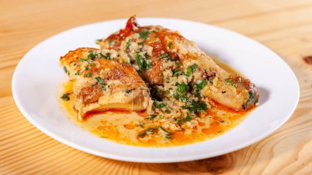 Photo for Shkmeruli is a traditional Georgian dish of chicken in garlic sauce in the white plate. Food - Royalty Free Image