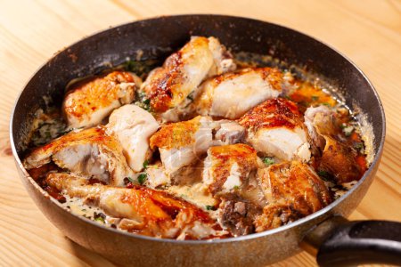 Photo for Shkmeruli, chicken in garlic sauce on a frying pan. Georgian national dish - Royalty Free Image