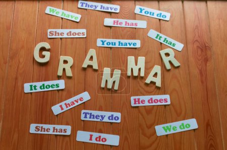 colorful English grammar cards on wooden table for studying
