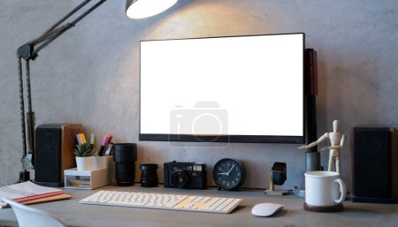 Photo for Creative workplace with computer, camera, stationery and coffee cup. Blank screen for your design. - Royalty Free Image