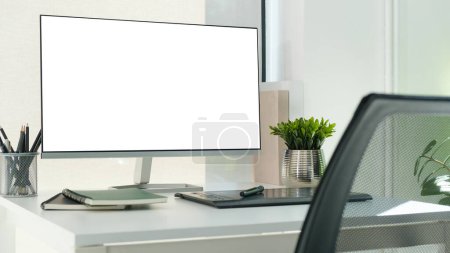 Photo for Comfortable workspace with blank screen comput and office supplies on a white wooden desk. - Royalty Free Image