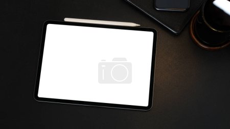 Foto de Digital tablet , stylus pen, notebook and cup of coffee on black leather table. - Imagen libre de derechos