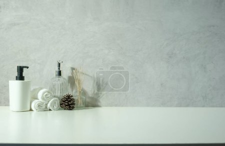 Photo for Various spa items with essential oils, towels, herbal compress balls on white table. Copy space for text. - Royalty Free Image