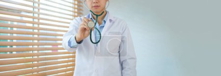 Photo for Male doctor wearing white coat  with stethoscope in hand. Healthcare and Medical concept. - Royalty Free Image