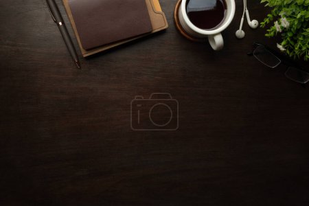 Téléchargez les photos : Top view of working desk with notebook, pen, potted plant and coffee cup. Copy space for your text. - en image libre de droit
