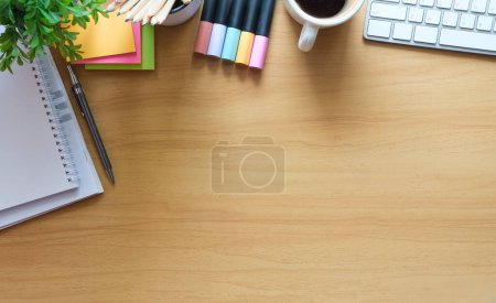 Photo for Top view of office supplies, coffee cup, notebook and keyboard on wooden desk. Copy space for your text message or information content. - Royalty Free Image